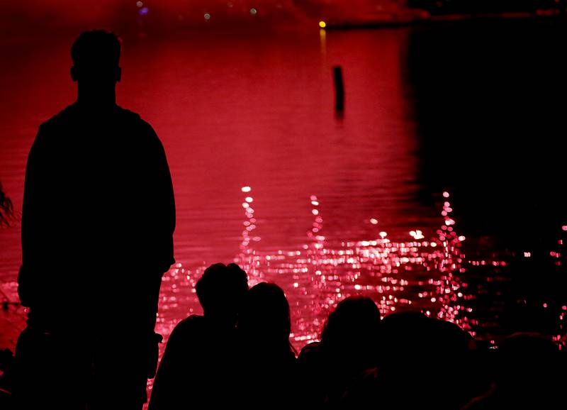 Young adults watch the fireworks show Sunday, July 2, 2023, at Crystal Lake’s Main Beach during Crystal Lake Annual Independence Day Celebration.