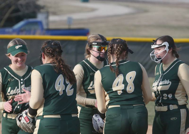 Members of the St. Bede softball team gather at the mound between innings on Monday, March 20, 2023 at St. Bede Academy.