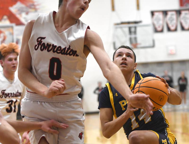 Polo's Jordan Reed (14) drives to the basket as Joseph Kobler defends on Saturday, Dec. 13, 2025 at the 64th Annual Forreston Holiday Basketball Tournament held at Forreston High School.