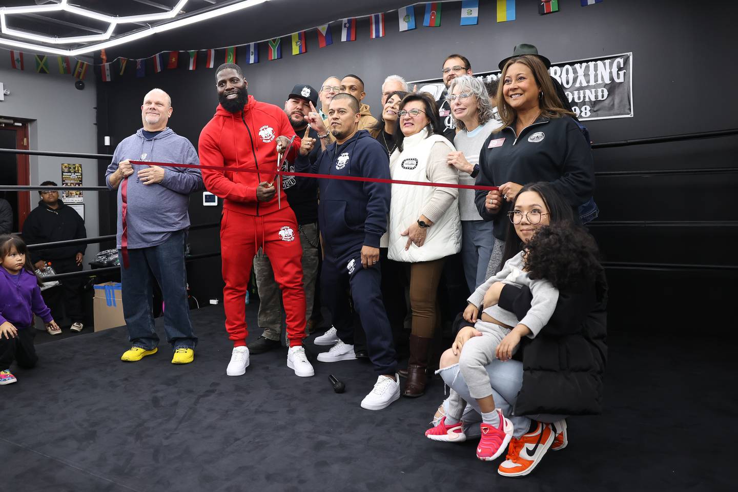 Co-owners Kenny Bragg holds the scissors along with Oscar Hernandez for the ribbon cutting ceremony of Spartan Boxing on Wednesday, Nov. 8, 2023 in Lockport.