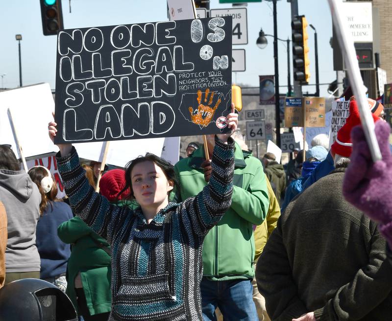 A demonstrator holds a sign at the No Kings rally on Saturday, March 28, 2026, in downtown Oregon, Illinois.