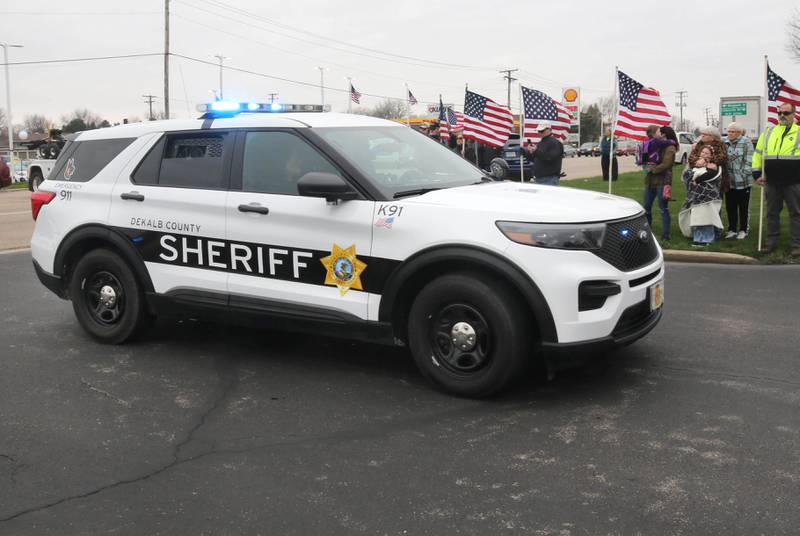 DeKalb County Sheriff vehicles pull into Butala Funeral Home Monday, April 1, 2024, following the hearse carrying the body of DeKalb County Sheriff’s Deputy Christina Musil during a processional to honor the fallen officer. Musil, 35, was killed Thursday while on duty after a truck rear-ended her police vehicle in Waterman.