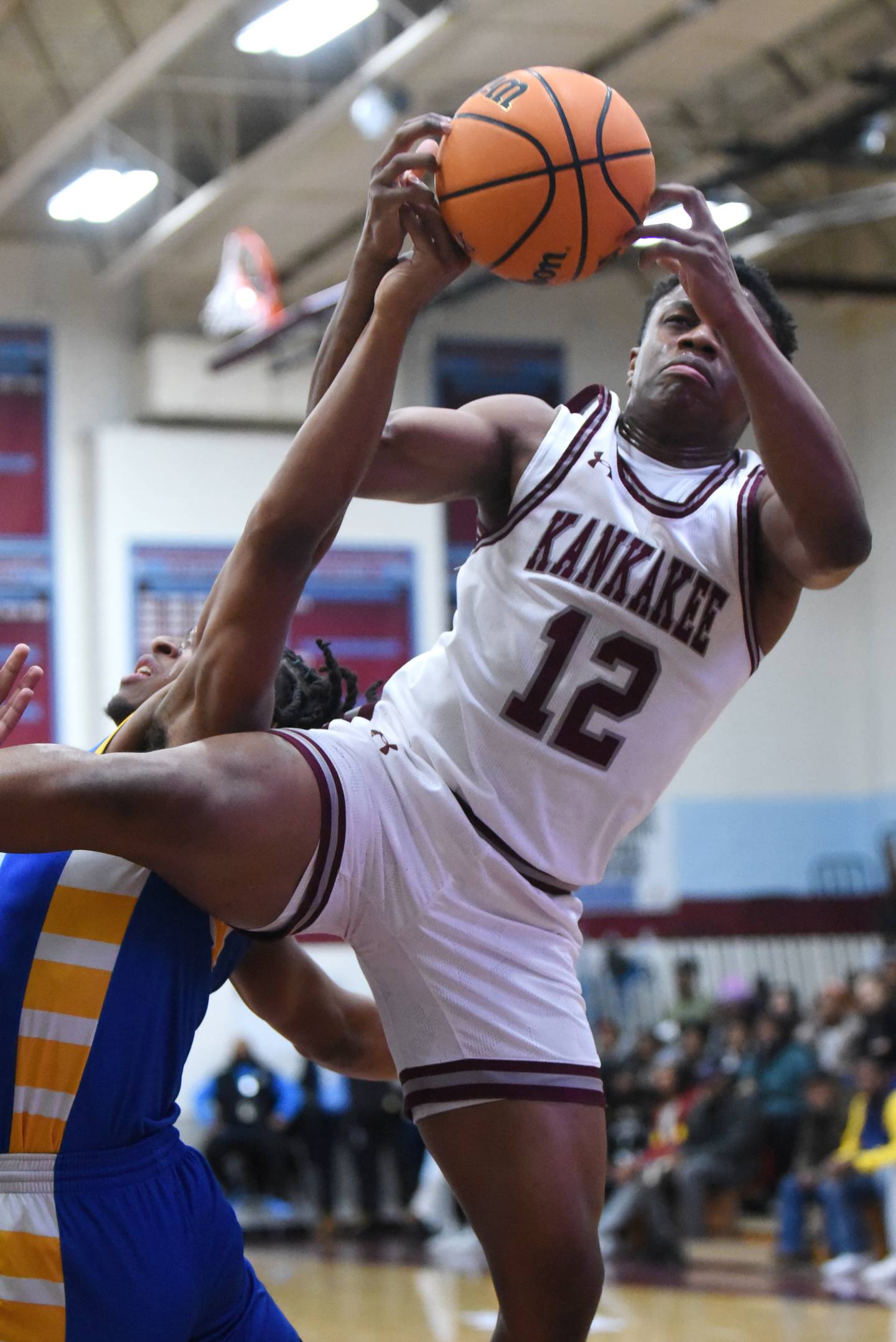 Kankakee's Myair Thompson, right, grabs a rebound over Crete-Monee's Zyheir Gardner during a boys basketball game at Kankakee High School Tuesday, Feb. 4, 2025.