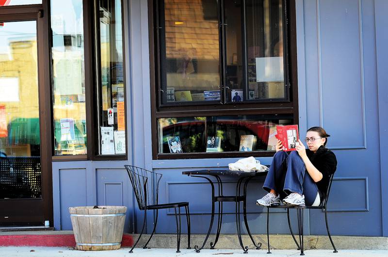 Emily Mekeel of Dixon sits outside of Books on First in downtown Dixon March 13, 2012, soaking up the warm weather. Mekeel, a student at NIU, is home on spring break.