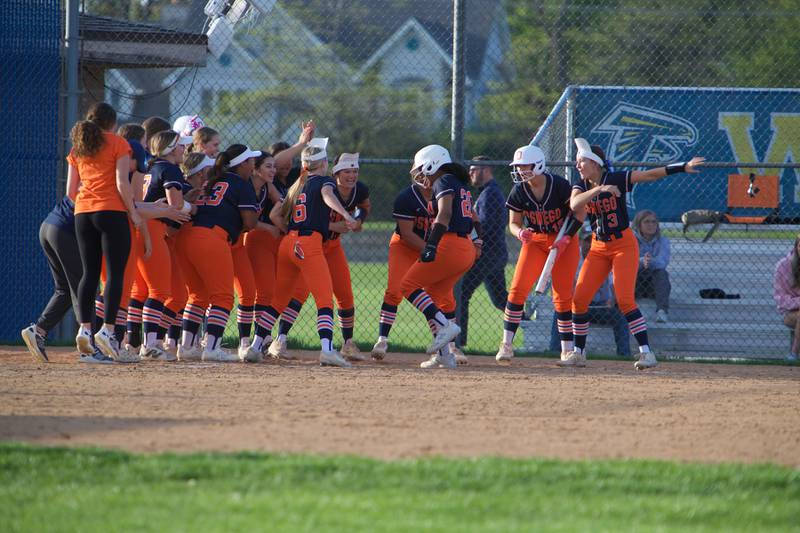 Oswego's Jaelynn Anthony  is greeted at home plate after hitting a homer against Wheaton North on Tuesday May 6, 2025 in Wheaton.