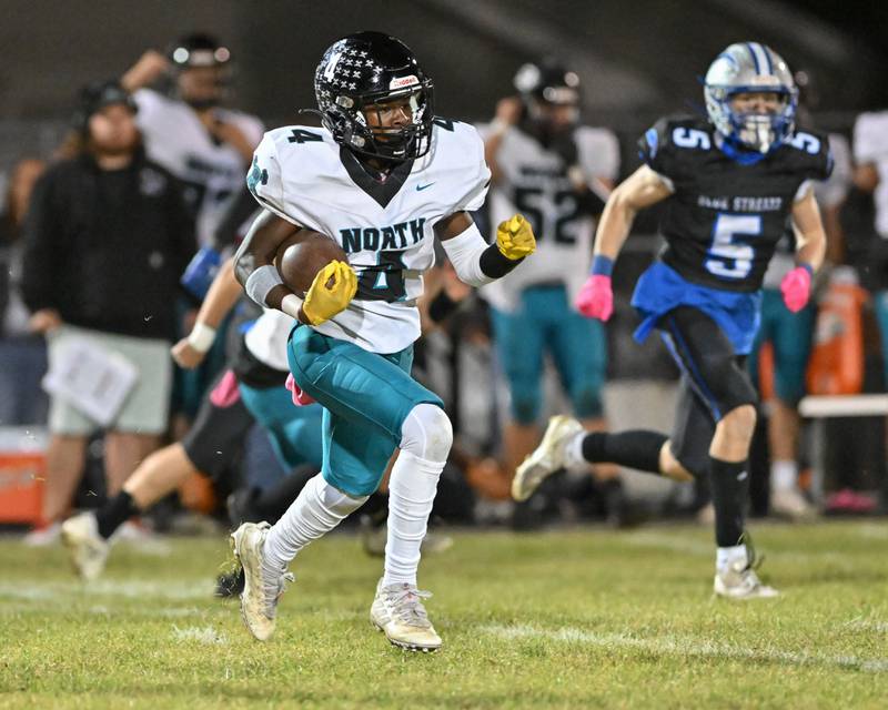 Woodstock North's Sean Mitchell runs for long yardage on a kickoff return against Kishwaukee River Conference and crosstown rival Woodstock on Friday, Oct. 25, 2024 at Woodstock H.S.