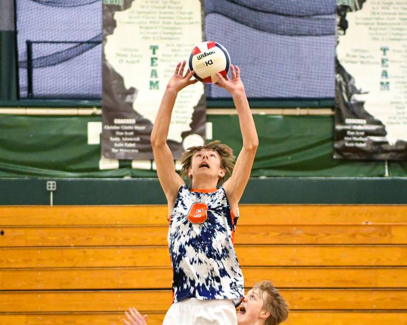 Oak Park River-Forest's Quinn Bozarth (8) sets the ball during the game on Tuesday April 16, 2024, while traveling to take on Glenbard West High School.