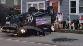 Car flips over, lands in front yard after hitting parked vehicle in Volo