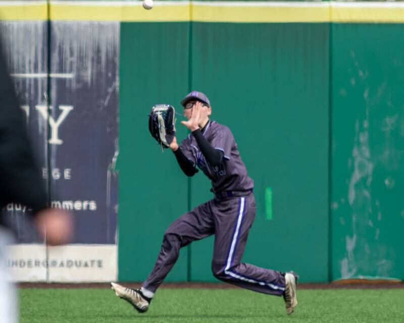 Hampshire's Wilson Wemhoff (21) looks in a catch from left field during baseball game between Dixon at Hampshire.  March 28, 2024