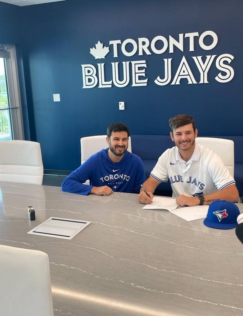 Rock Falls grad Jay Schueler, right, is pictured signing his contract with the Toronto Blue Jays. Brandon Bishoff, left, is the Blue Jays' crosschecker who oversees the signings.