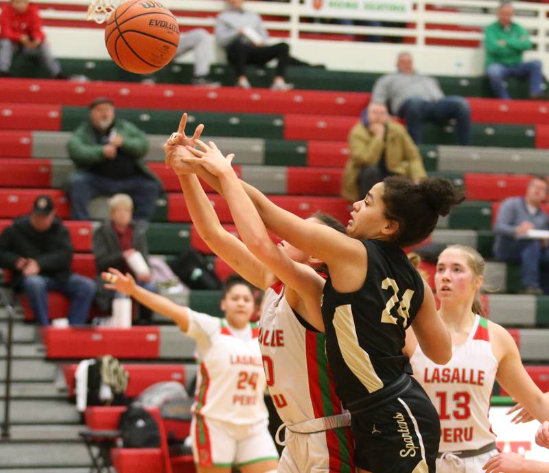 Sycamore's Monroe McGhee looks to grab a rebound over L-P's Bailey Pode on Tuesday, Jan. 31, 2023 at L-P High School.