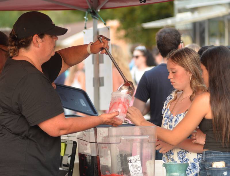 Michelle Carreno serves up a cool lemonade at Hector's Coxina food truck at the Let Freedom Ring block party on  Friday, July 4, 2025 in Mt. Morris.
