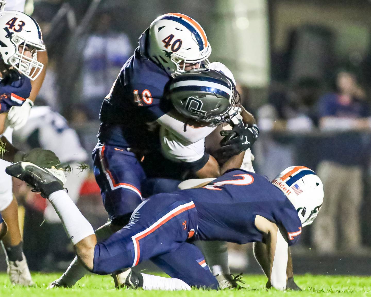 Oswego senior linebacker Conor Tully (40) wraps up an Oswego East ballcarrier during their 2025 football game.