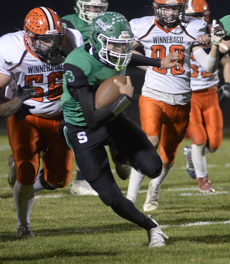 Seneca’s Nathan Grant breaks through the Winnebago line to score on a run in the 1st quarter during the Class 3A first round playoff game on Friday, Oct. 28, 2022 at Seneca.