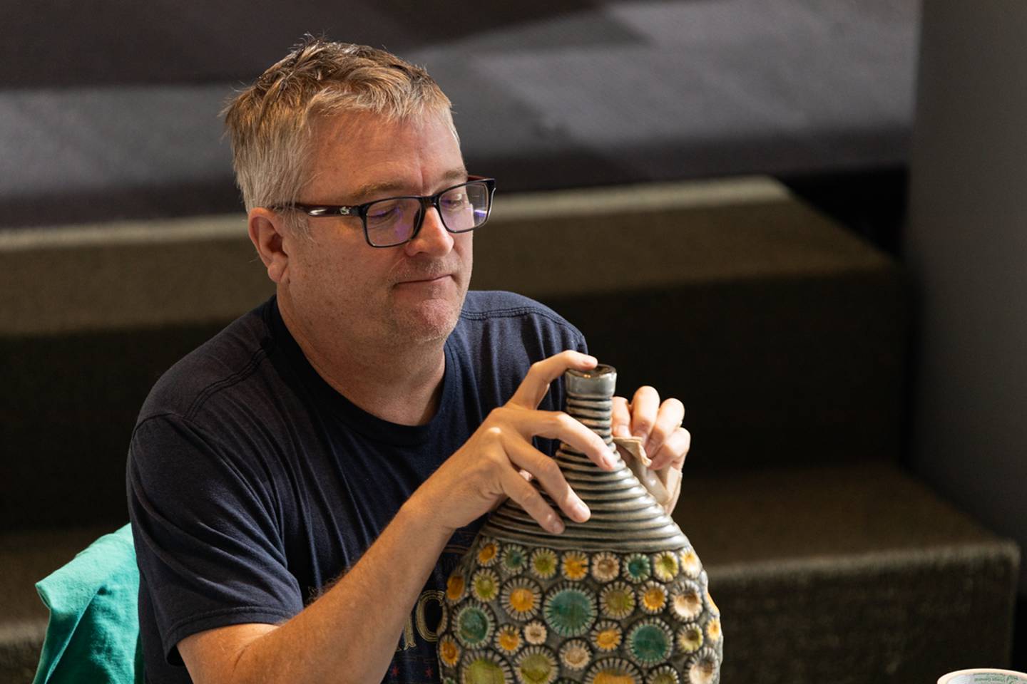 Eric Gorder repairs a ceramic vase during the Pilot Repair Cafe at JJC Romeoville in October 2023.