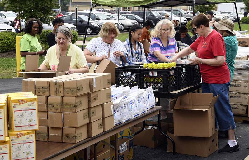 People line up for free food Saturday from the Northern Illinois Food Bank at the annual Sharefest in New Lenox.