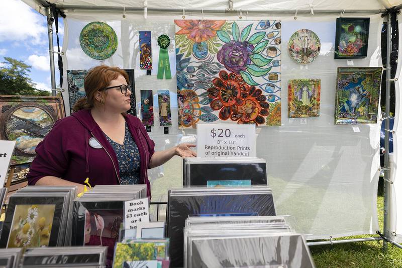 Rachel Newell of Peoria puts on display her art Sunday, Sept. 7, 2025, at the Grand Detour Arts Festival. Newell creates eccentric scenes using collage stylings and bright colors.