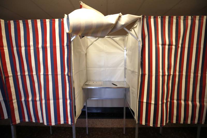 FILE - A booth is ready for a voter, Feb. 24, 2020, at City Hall in Cambridge, Mass., on the first morning of early voting in the state. Thanks to recent advances in artificial intelligence, tools that can create lifelike photos, video and audio are now cheap and readily available. AI experts and political scientists say these new programs will have significant implications for next year's U.S. elections. (AP Photo/Elise Amendola, File)