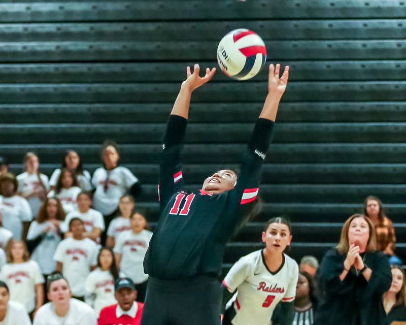 Bolingbrook's Alana Cruz (11) sets a shot during regional final volleyball match between Bolingbrook at Joliet West.  Oct 26, 2023.