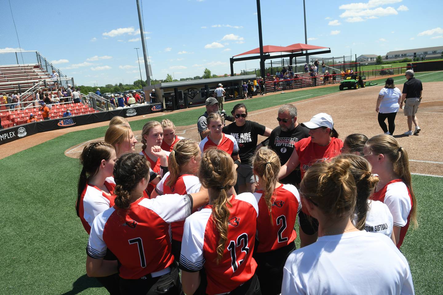 Forreston coach Kim Snider and assistant coaches Erin Kennelly and Kirk Janicke talk to team members after they fell to Casey-Westfield 4-0 in semifinal action at the 1A softball finals in Peoria on Friday, June 3.