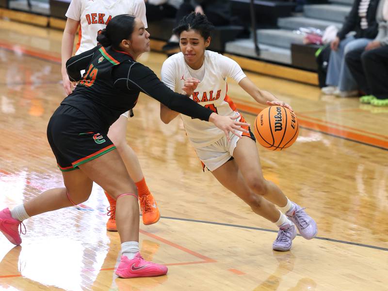 DeKalb's Nazeria Dean drives around Plainfield East's Valeria Ramos Thursday, Feb. 12, 2026, during their game at DeKalb High School.