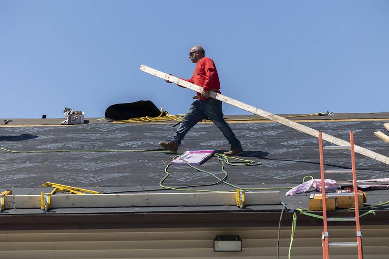 TCS, Total Construction Services of Sterling, work on the roof of the Twin Cities Homeless Shelter, formerly the PADS Homeless Shelter, on Friday, April 19, 2024, in Sterling.