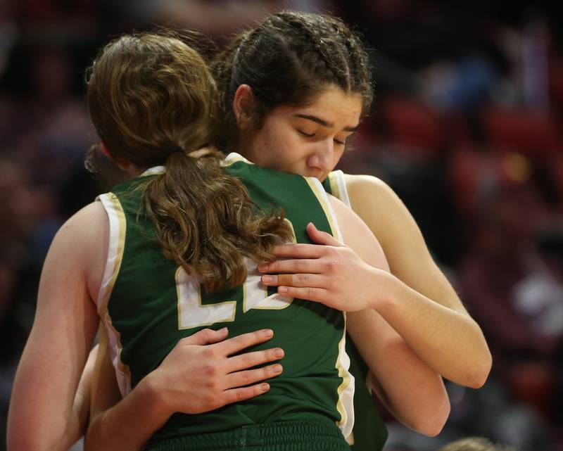 St. Bede's Ali Bosnich hugs teammate Lili McClain during the Class 1A third-place game on Thursday, Feb. 29, 2024 at CEFCU Arena in Normal.