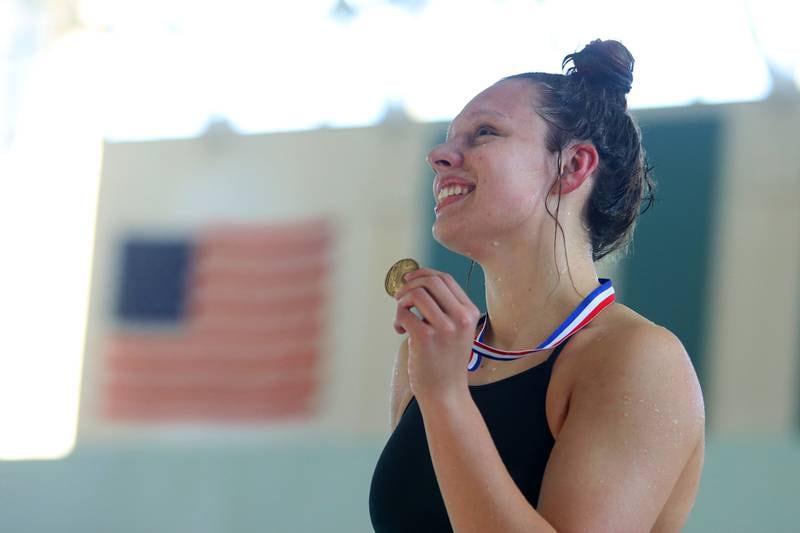 Bella Fontana of Crystal Lake South co-op displays her first place medal after the 200-yard freestyle during the Fox Valley Conference Championship Meet at Woodstock North High School on Saturday, Nov. 2, 2024 in Woodstock .