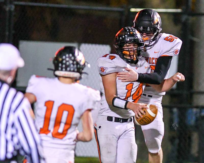 Sandwich’s Peter Popp, right, celebrates with teammate Caleb Jones, center, after scoring a touchdown in the fourth quarter as they took on Dyett High School at Gately Stadium in Chicago.