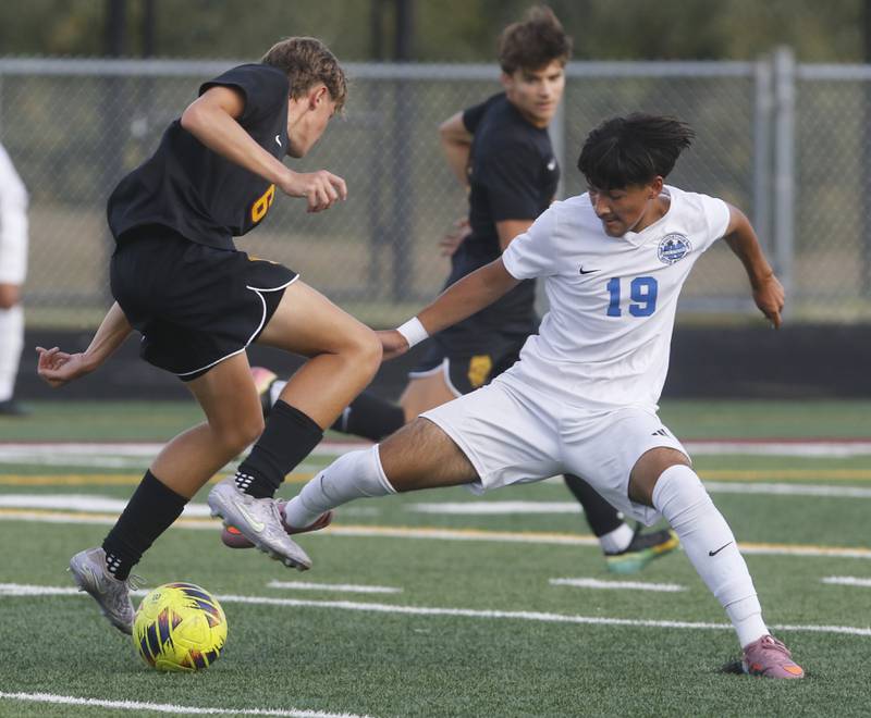 Richmond-Burton’s Brayden Mumbower tries to get past the defense of Woodstock's Diego Najera Mercado during a Kishwaukee River Conference soccer match on Wednesday, Sept. 10, 2025, at Richmond-Burton High School, in Richmond.