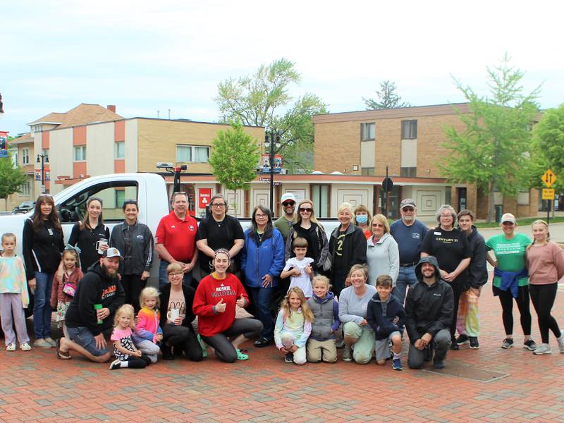 Pictured: 30 people representing a dozen DeKalb businesses and organizations planting in the downtown’s in-ground planters on Saturday, May 21.