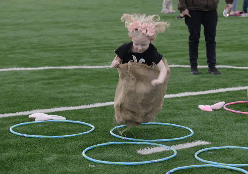 Everly Wyattl of Glendale Heights hops her way through hula hoops during the Glen Ellyn Park District's Hoppy party Saturday, March 30, 2024.