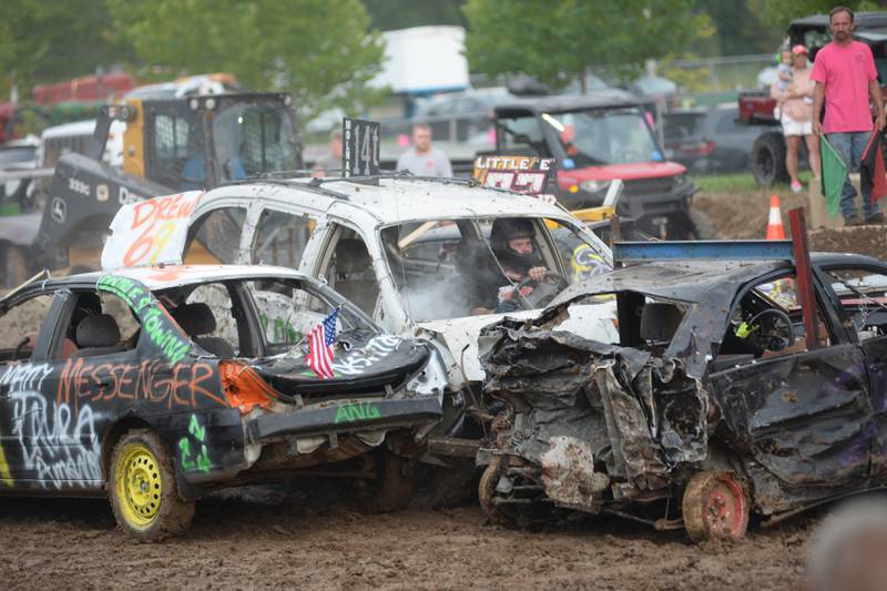 Andrew Powell of Kings gets crushed in his white vehicle during the Open Wire Compact heat of the demolition derby at the Ogle County Fair on Saturday, Aug.5, 2023.