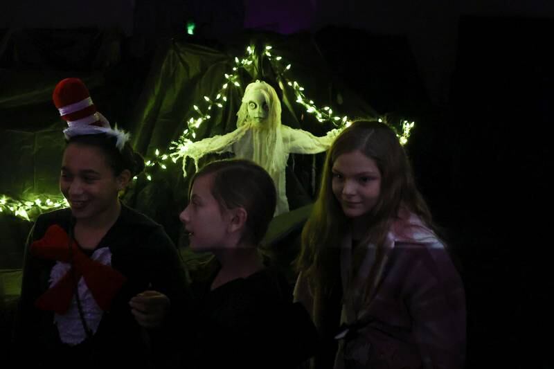 Kids walk through the Haunted Lab at the STEAM Spooktacular hosted by the After the Peanut Foundation on Wednesday at Lewis University.