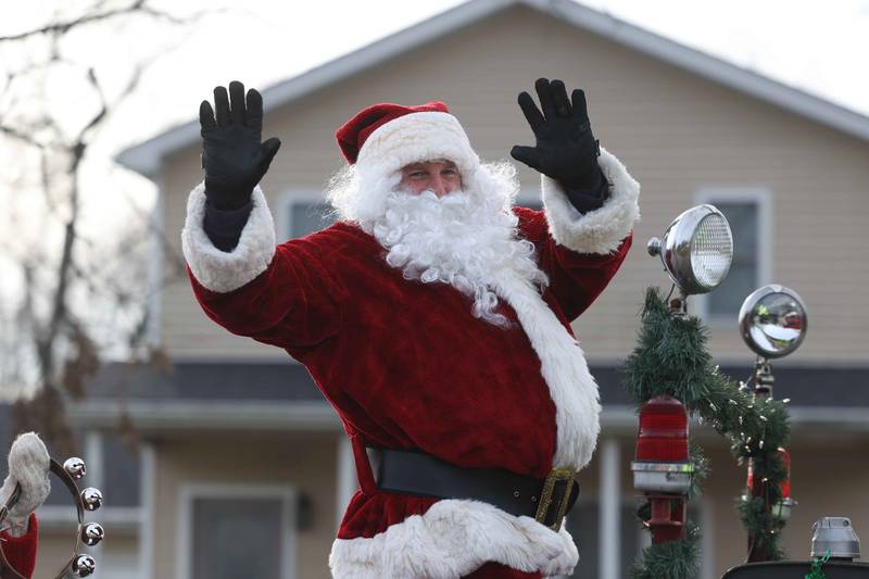 Santa waves to the people as the Joliet police, fire and public works vehicles escort him through Joliet before he heads off to the North Pole for the annual Santa Send-Off on Saturday, Dec. 14, 2024 in Joliet.