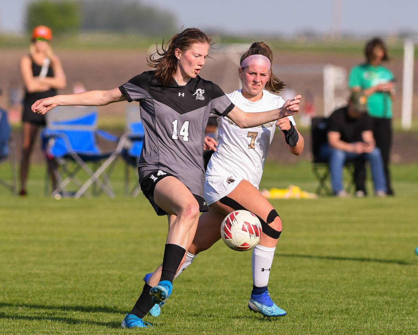 Kaneland's Erin Doucette (14) and Sycamore's Anya Berry (7) battle for the ball during the second half of the game on Tuesday May 6, 2024, held at Sycamore High School.
