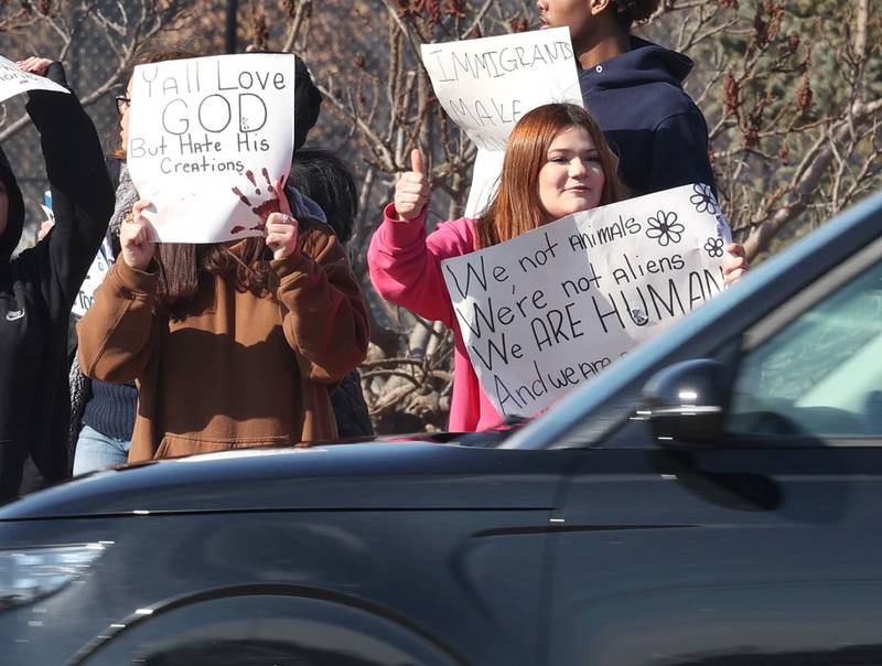 DeKalb High School cheer as passing motorists honk in support during a protest Tuesday, Feb. 10, 2026, on Sycamore Road in front of Hopkins Park in DeKalb. The students walked out of school Tuesday to protest against ICE involved violence and arrests.
