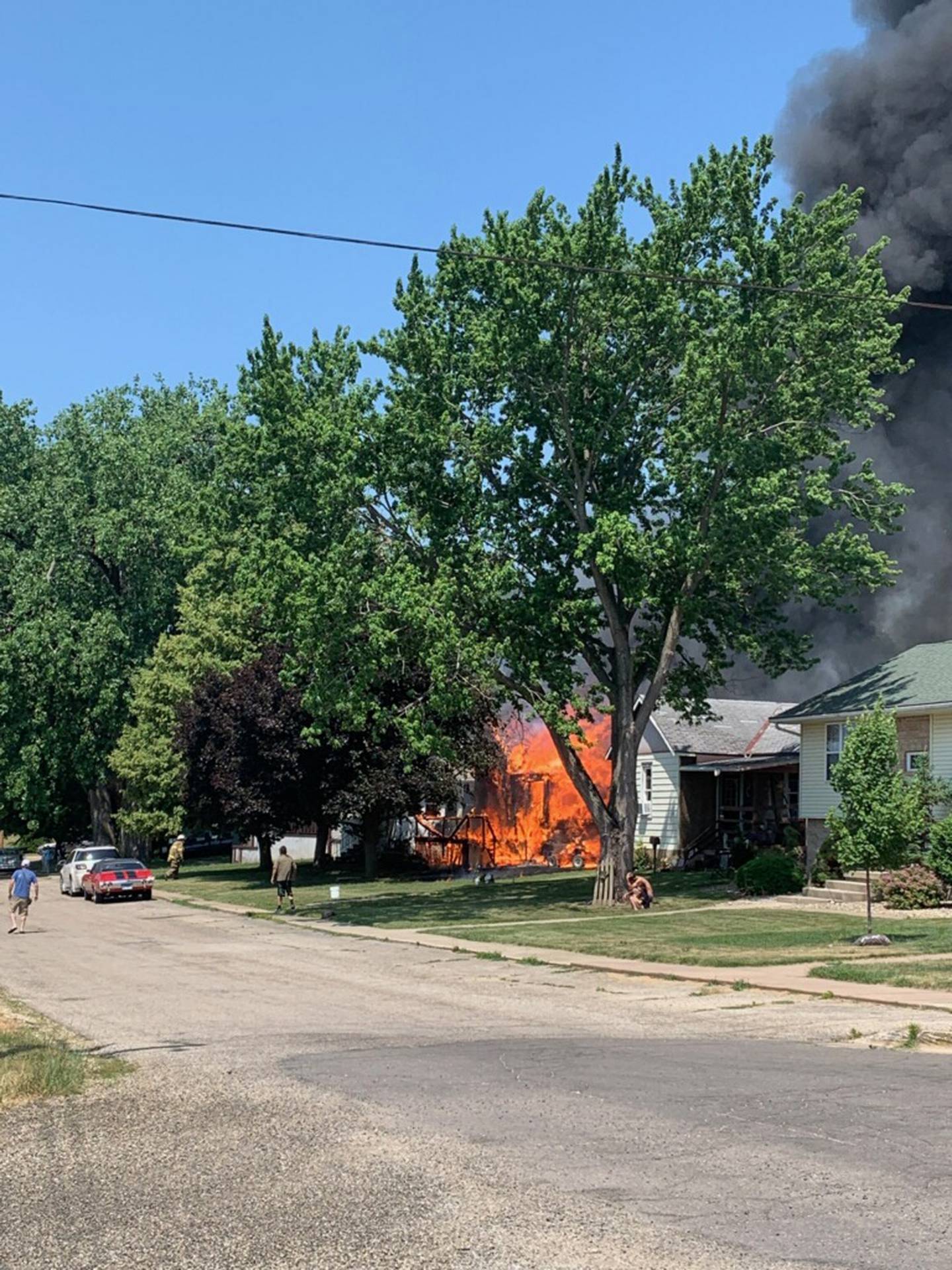 Homes on the 200 block of East Caroline Street are engulfed in flames Saturday, June 10, 2023.