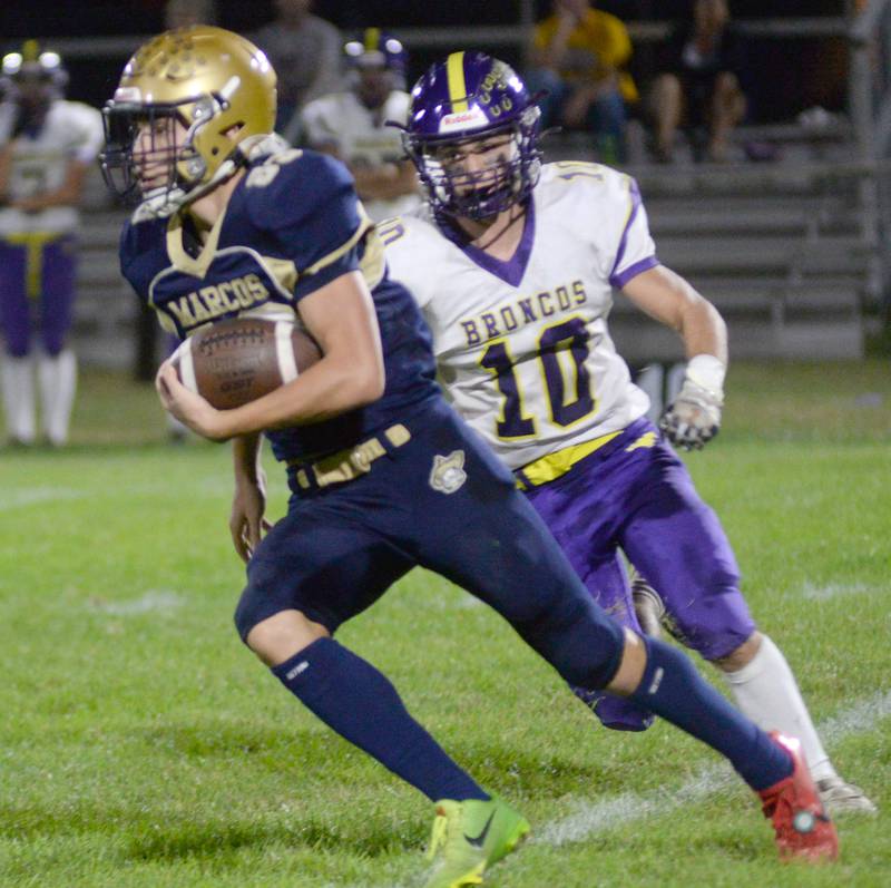 Polo's Mercer Mumford (83) runs past Orangeville's Oskar Bissell during 8-man action at Polo High School on Friday, Oct. 3, 2025.