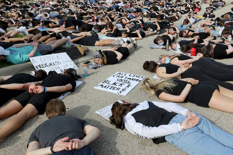 Hundreds of peaceful protesters lay face down in the parking lot for 9 minutes as a symbol of solidarity, mimicking the situation that resulted in the death of George Floyd, during a Black Lives Matter rally which started at Veteran Acres Park and moved to the city hall and police department on Wednesday, June 3, 2020 in Crystal Lake.