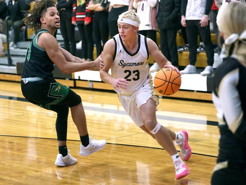Sycamore's Carter York drives around North Boone’s Azriel Dixon during their game Tuesday, Dec. 3, 2024, at Sycamore High School.