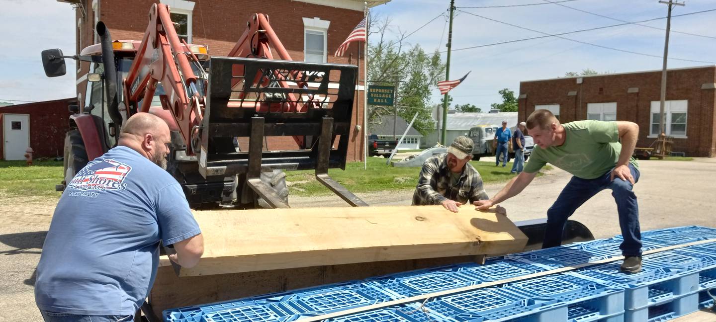 Rodney Bennett, Clifford Stetson and Tom Weeks loading oak and cannon for restoration in Georgia.