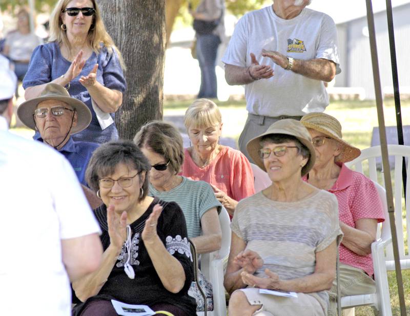 Visitors applaud a presenter during the Lee County Historical and Genealogical Society's cemetery walk at Oakwood Cemetery in Dixon on Sunday, Sept. 28.