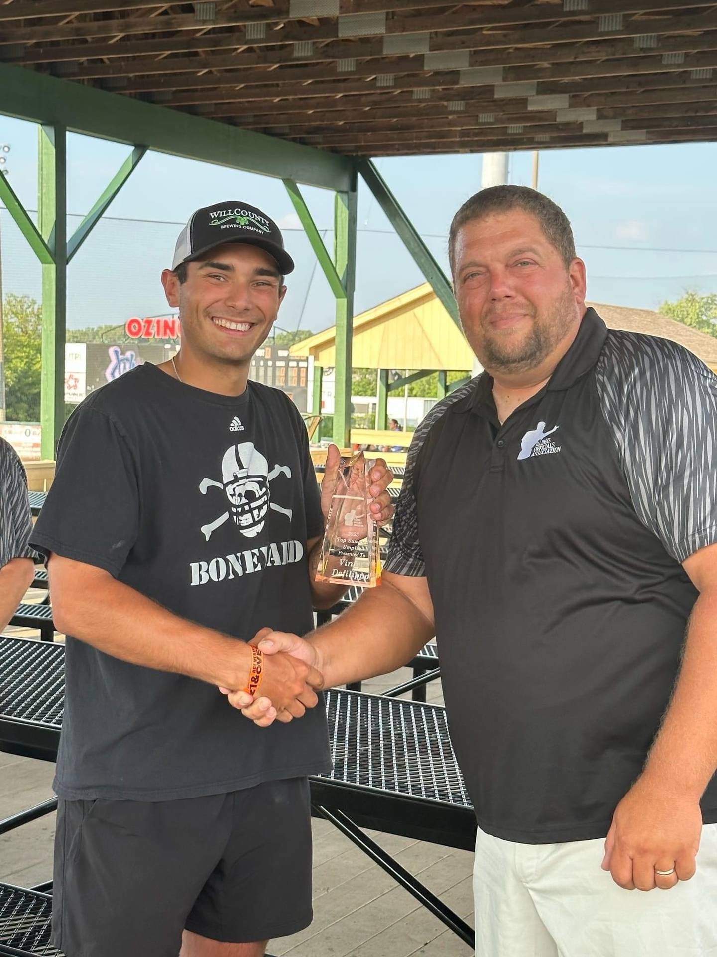 Joliet native Vinny DeFilippo (at left) was named the Illinois Officials Association's Top Summer Umpire for 2023, one of two local young umpires to be honored by the IOA and its president, Ryan Verver (at right), this year.
