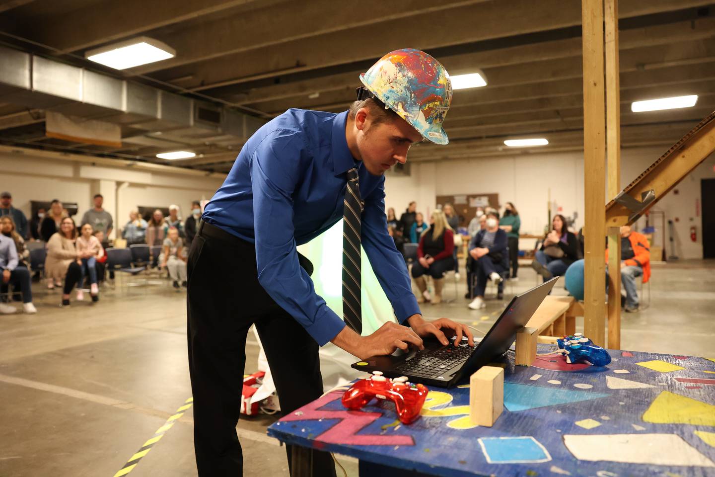 Steel Tigers Robotics Team 4241 head programer Matthew Papesh, a senior at Joliet West, starts up the robot at the unveiling of their robot for the upcoming FIRST Robotics Midwest Regional Competition. Wednesday, April 6, 2022, in Joliet.