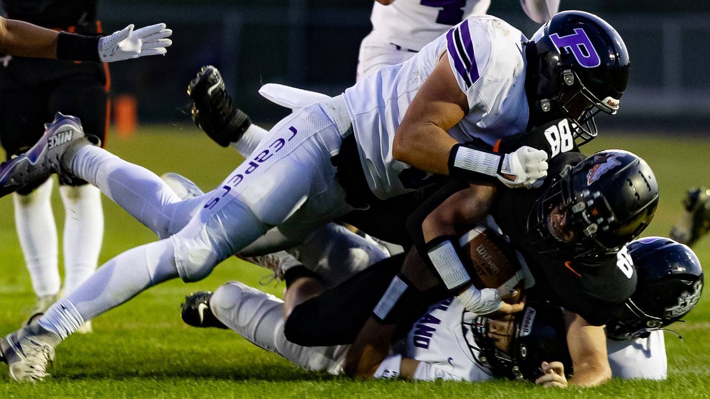 Plano's Cooper Beaty (9) makes a tackle during their game with Sandwich on Friday, Sept. 12, 2025.