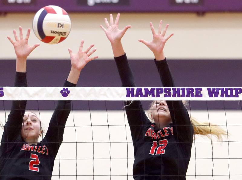 Huntley’s Rachael Hein, left, and Summer Massow block in varsity girls volleyball at Hampshire High School in Hampshire on Tuesday, Sept. 23, 2025.
