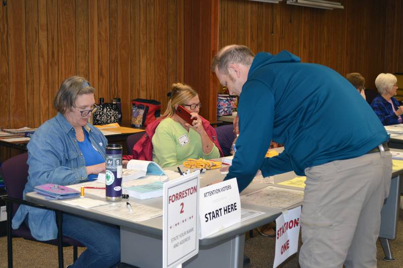 Dane Busker fills out the paperwork to get his ballot to vote in the consolidated election in the Forreston Township building on April 4, 2023. About 80 people had voted in the precinct as of 3:06 p.m.