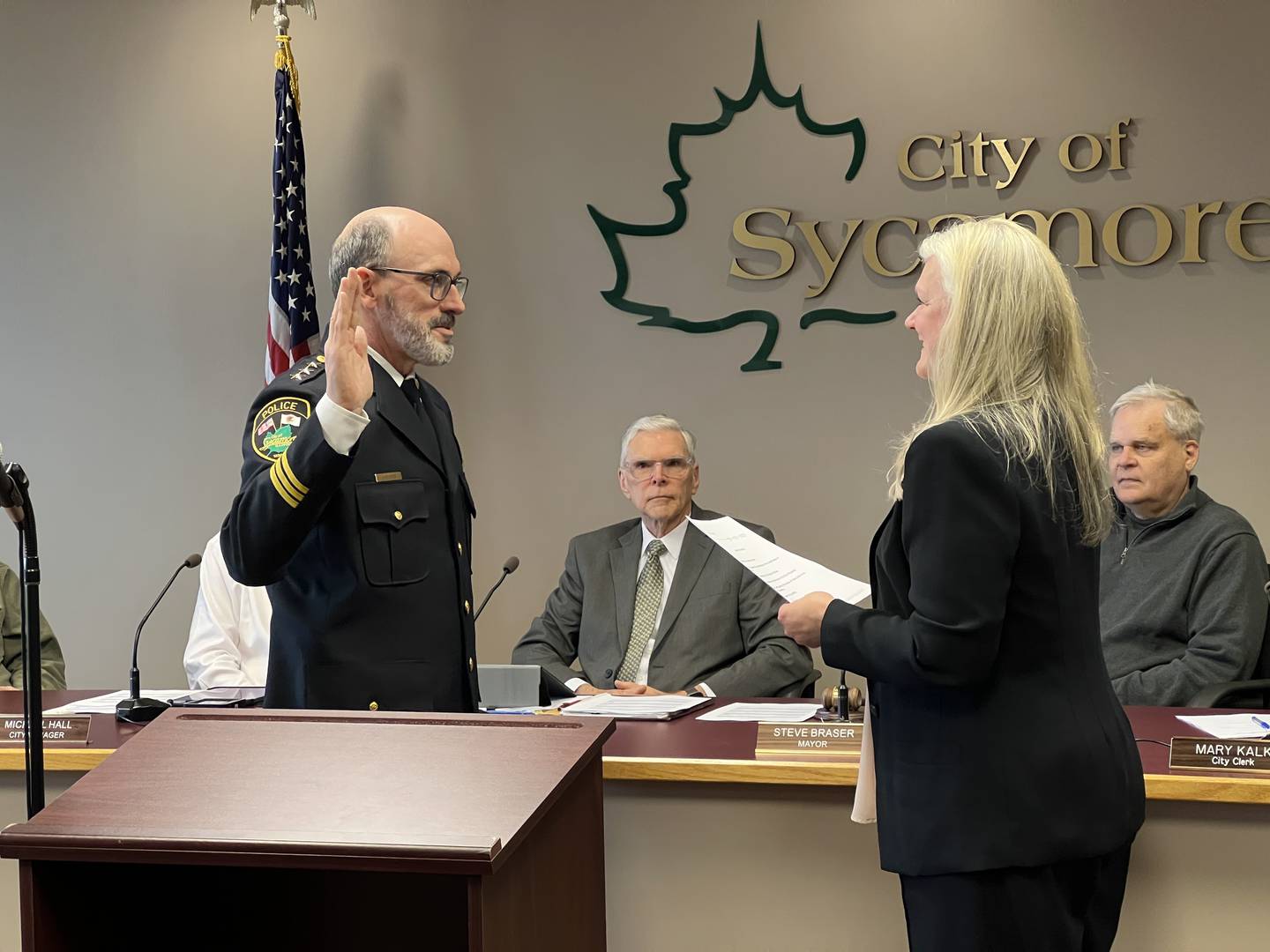Erik Mahan raises his right hand, while Sycamore lawyer and Keith Foster and Sycamore Mayor Steve Braser watch as Sycamore City Clerk Mary Kalk swears him in as the new Sycamore Police Chief on March 17, 2025.