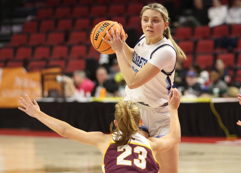 Nazareth's Stella Sakalas passes the ball around Loyola's Marycait Mackie during the Class 4A State girls basketball championship game on Saturday, March 7, 2026 at CEFCU Arena in Normal.